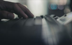 male hand on keyboard side blurred
