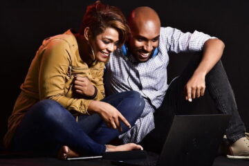 man and woman smiling at Dell laptop