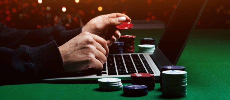 online casino man hands on laptop with chips