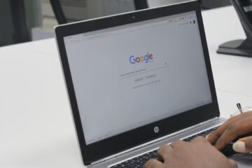 hands on hp laptop keyboard with google on screen