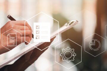 hand pen on clipboard charts cogs automation software