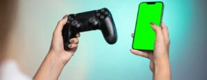 game console in one hand - mobile phone in other hand