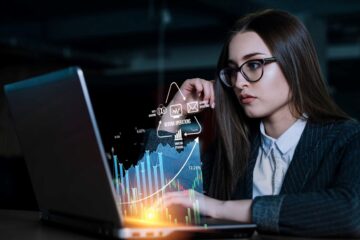 young women looking at financial graphs charts on laptop computer